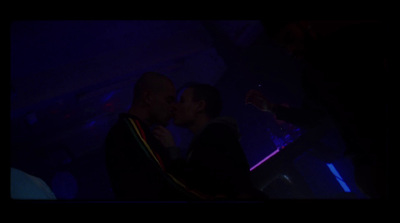 a man and a woman kissing in a dark room