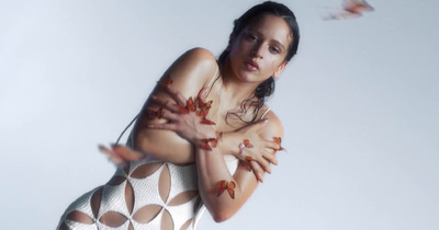 a woman with butterflies on her body posing for a picture