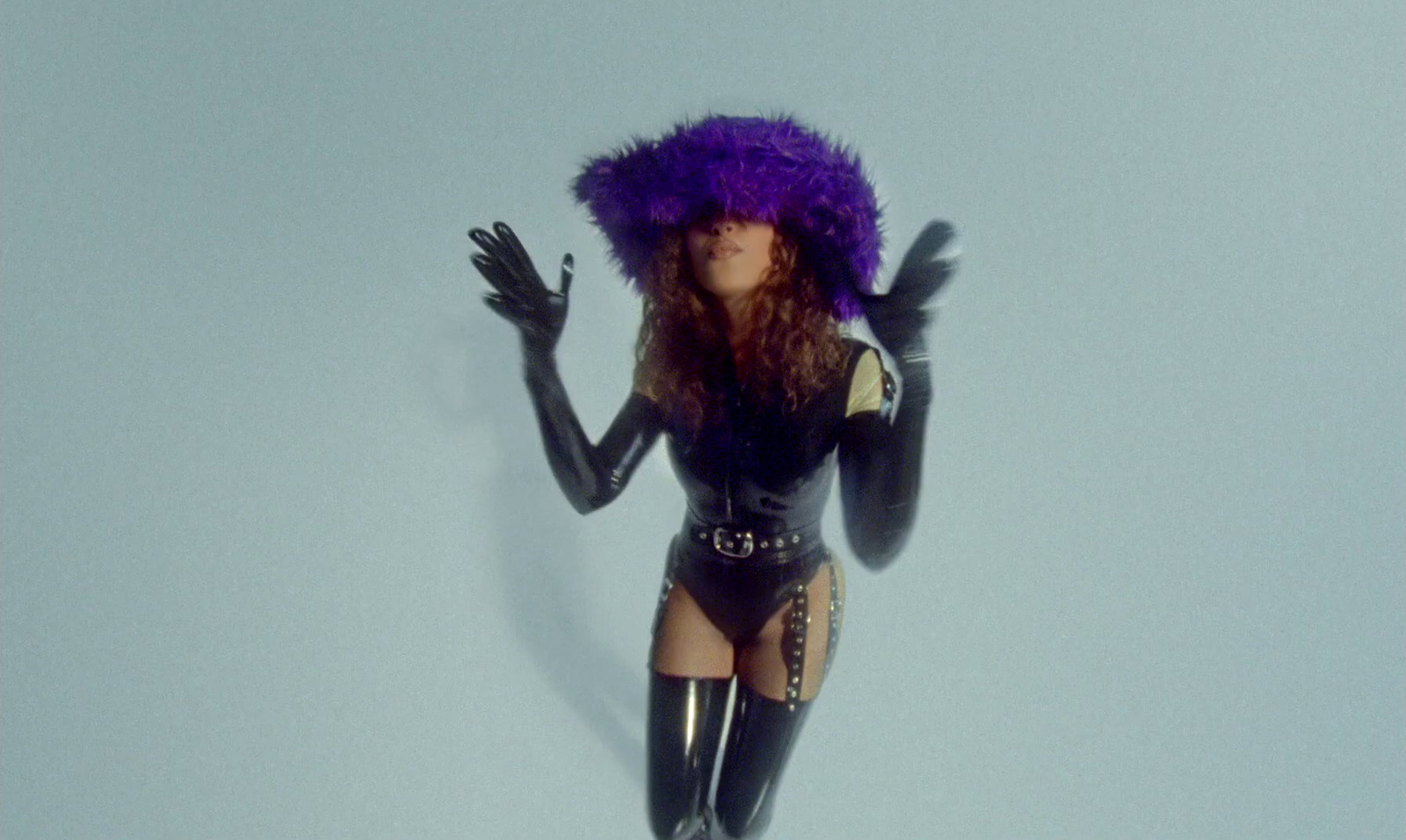 a woman wearing a purple wig and boots