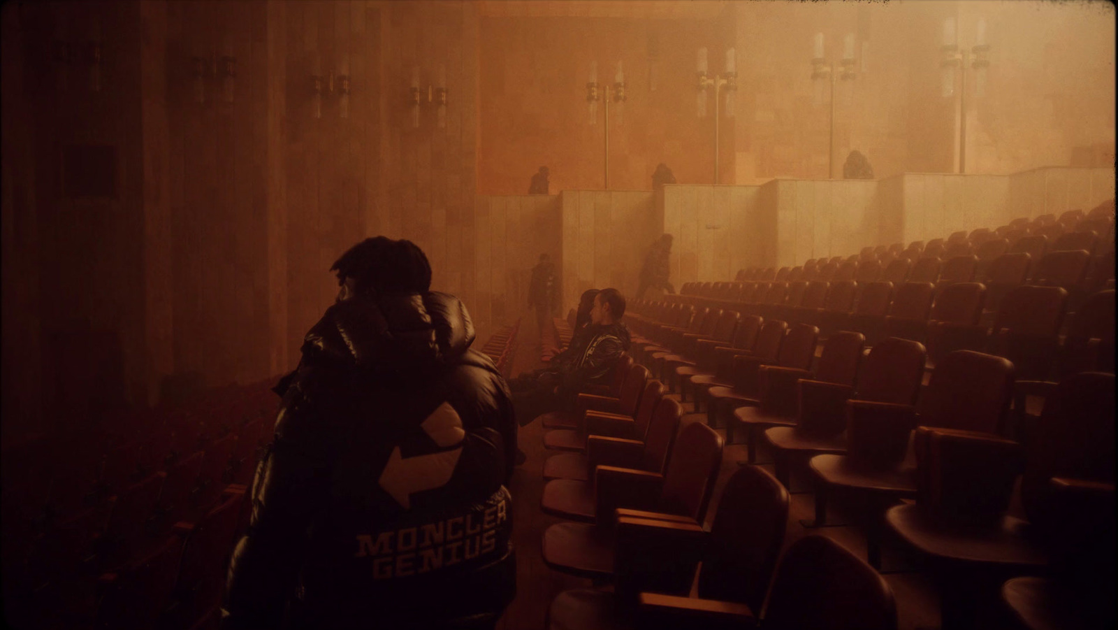 a man standing in front of a row of empty chairs