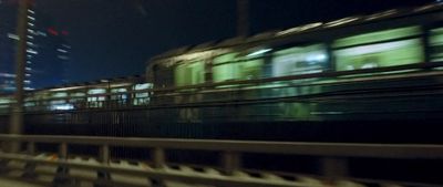 a train traveling down train tracks at night