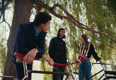 a group of people standing next to each other near a tree