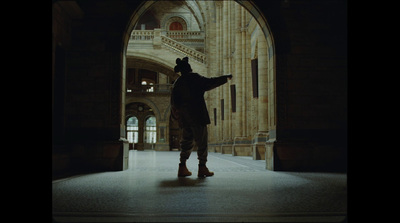 a person standing in a doorway with a hat on