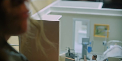 a woman in a hospital room looking in a mirror