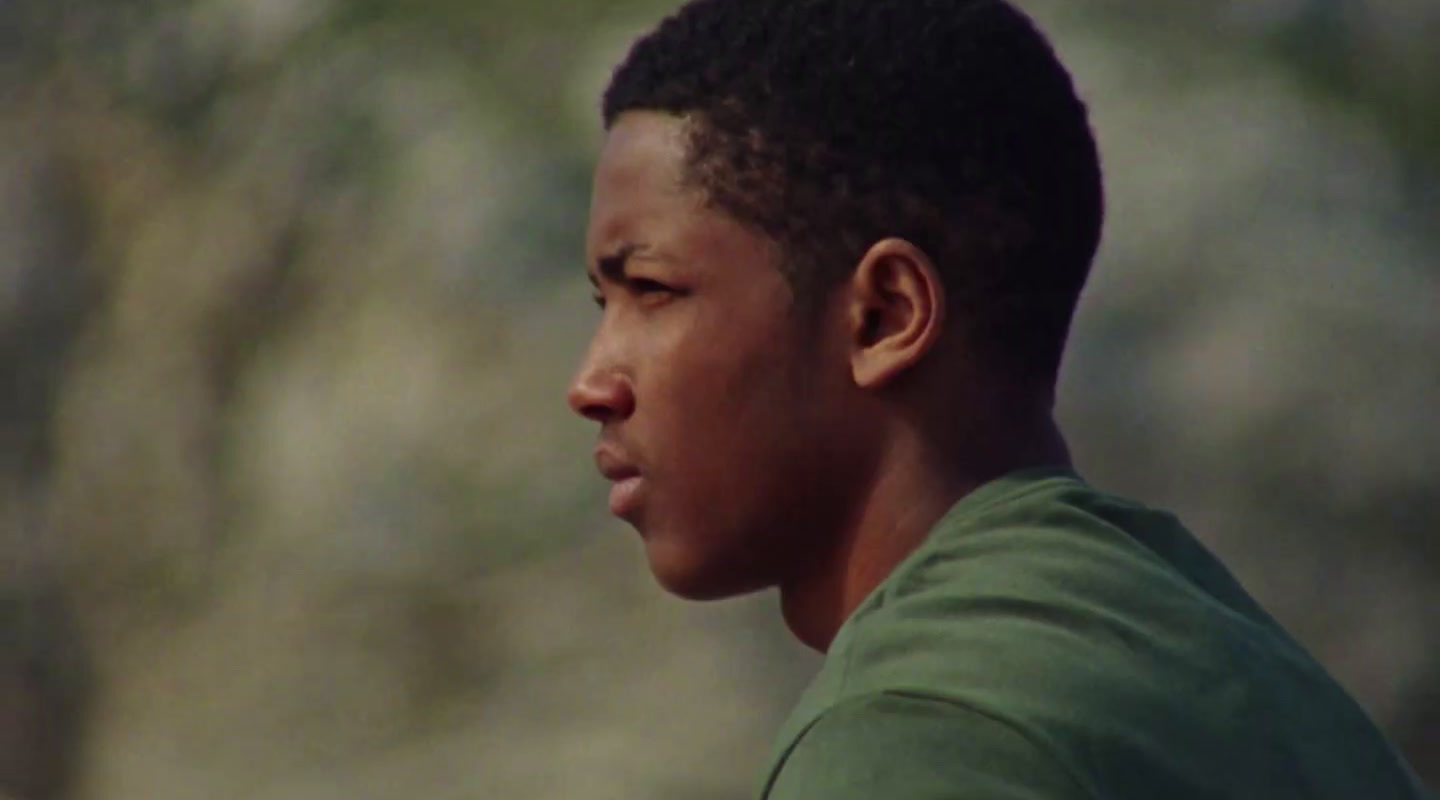 a close up of a person wearing a green shirt