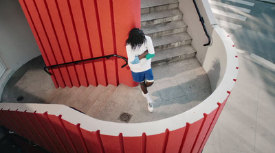 a woman is walking down the stairs of a building