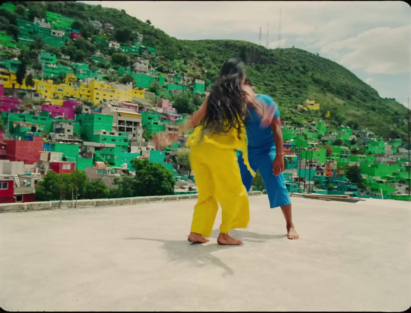 a couple of people standing on top of a roof