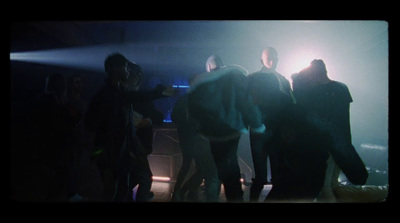 a group of people standing around in a dark room