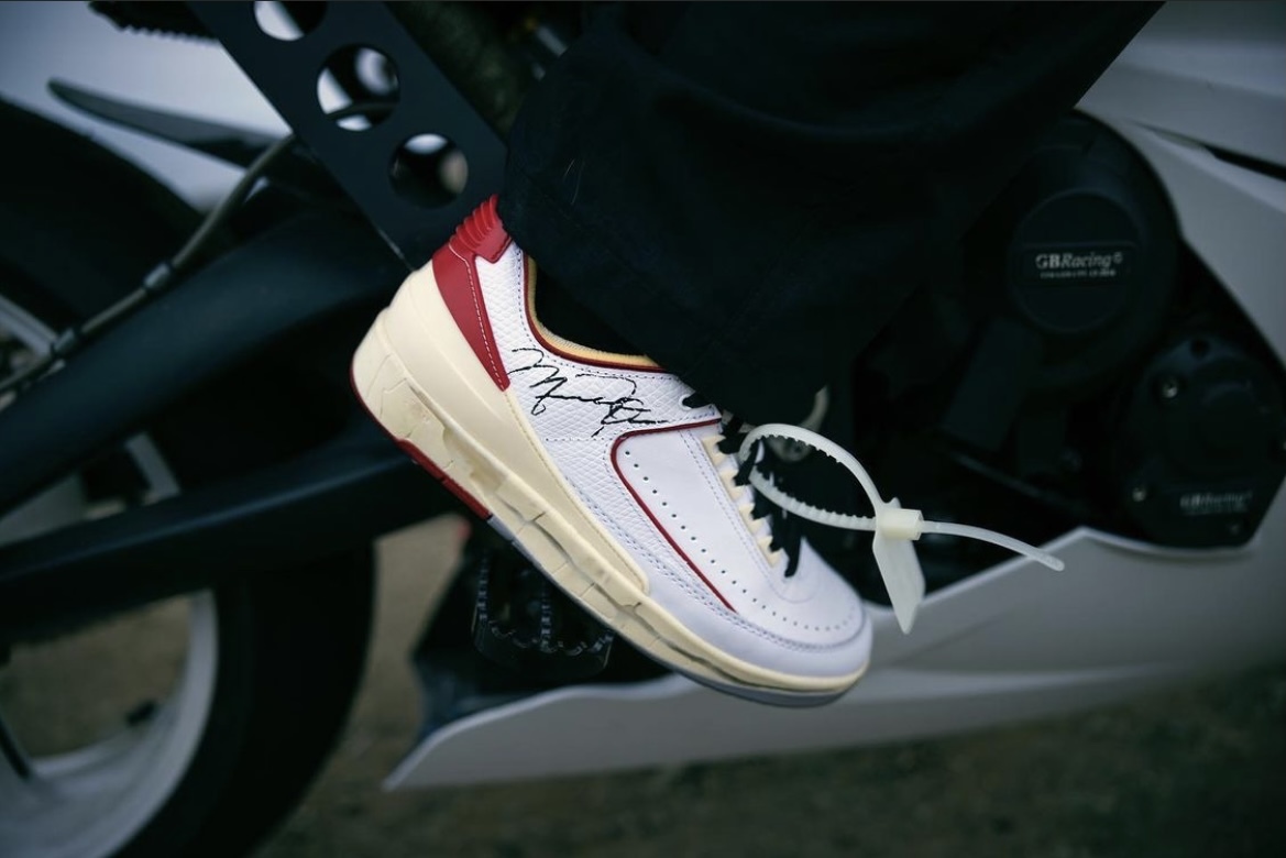 a person is standing on a motorcycle with a shoelace