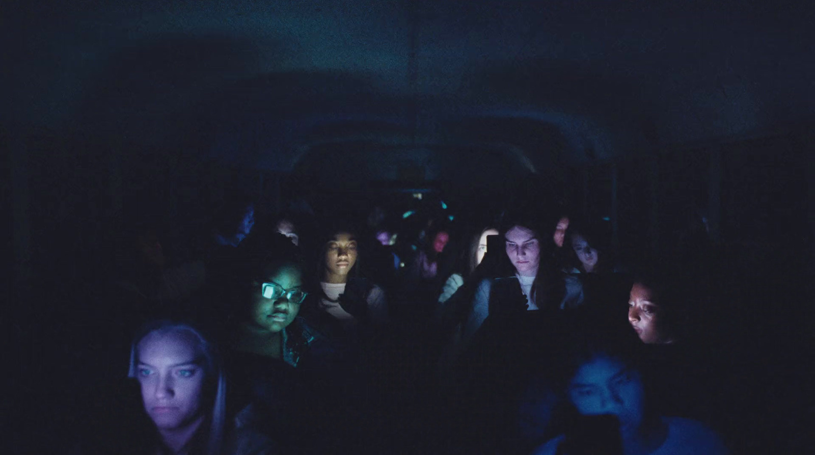 a group of people sitting in a dark room