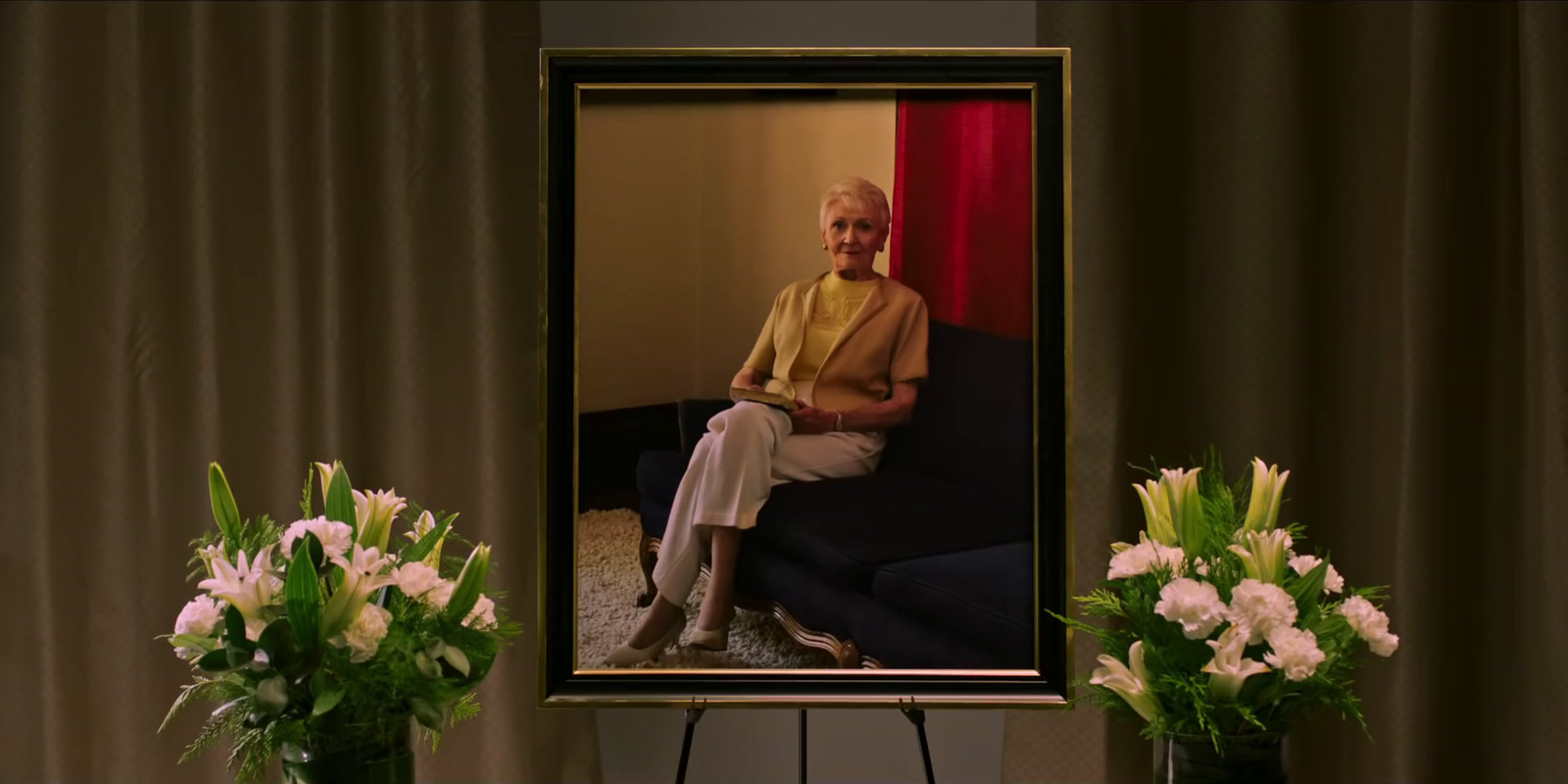 a woman sitting on a couch in front of a picture