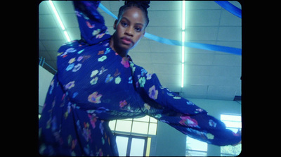 a woman in a blue floral print dress