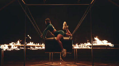 a woman sitting on a chair in front of a fire