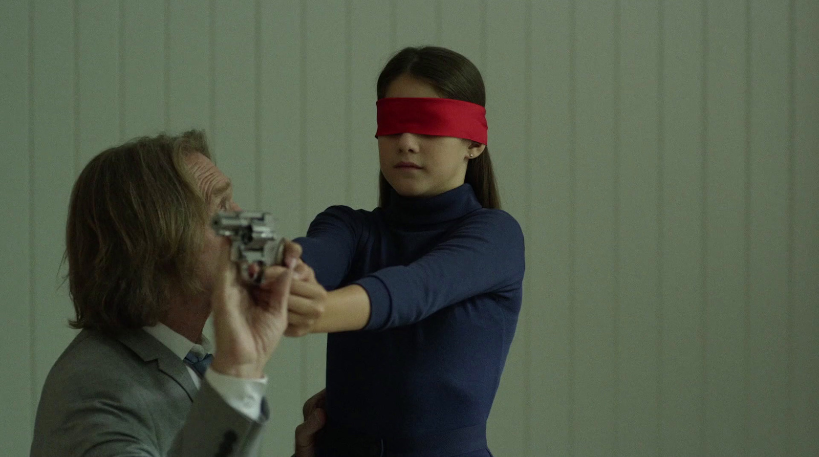 a woman with a blindfold holding a gun