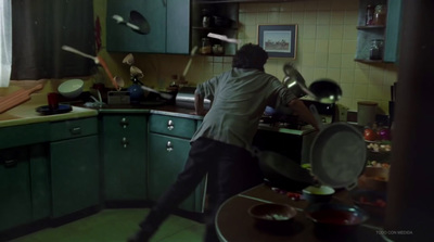 a man standing in a kitchen preparing food