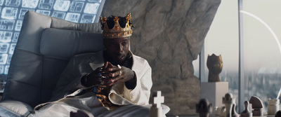 a man sitting in a chair with a crown on his head