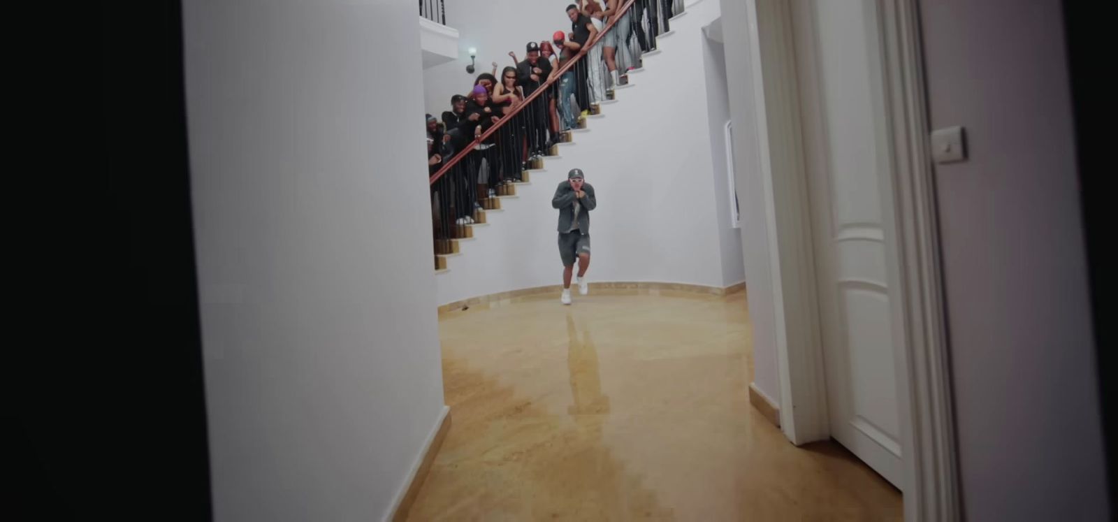 a woman is walking down a staircase with a group of people