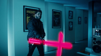 a man holding a neon pink object in a room