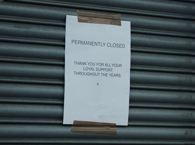 a sign posted on the side of a building