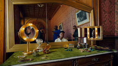 a vanity with a mirror and a couple of people in the mirror