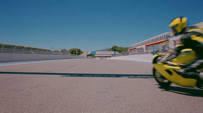 a person riding a yellow motorcycle on a race track