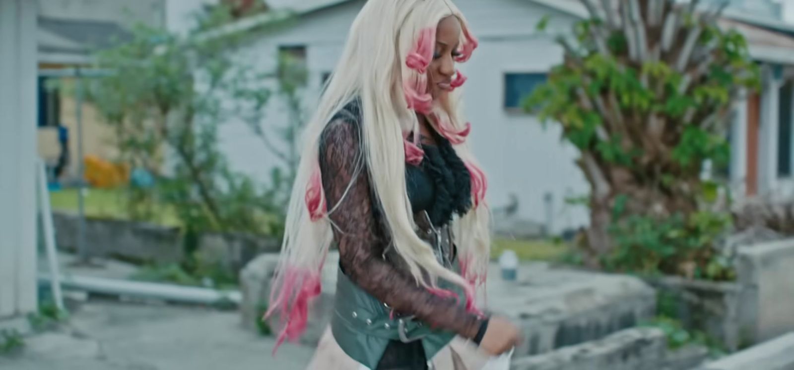 a woman with long blonde hair walking down a street