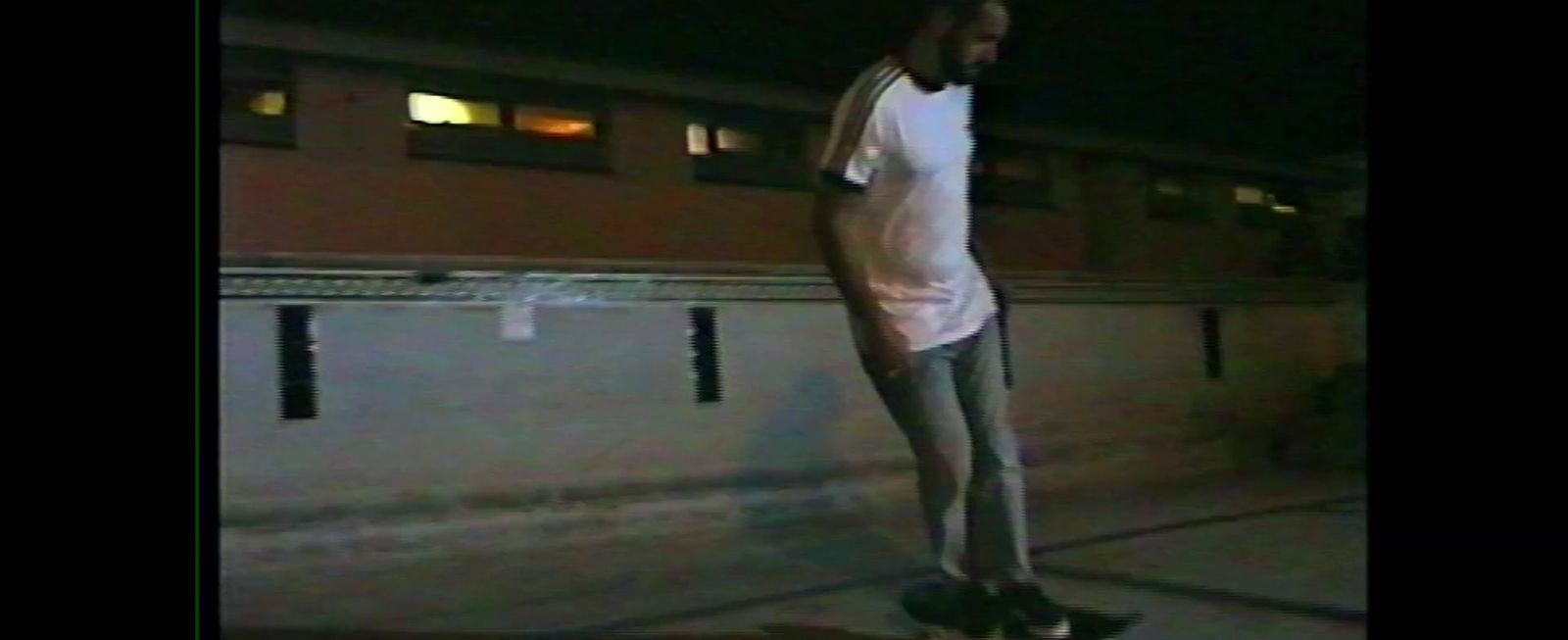 a man standing on top of a skateboard on a sidewalk