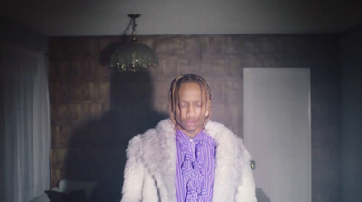 a man with dreadlocks standing in a room