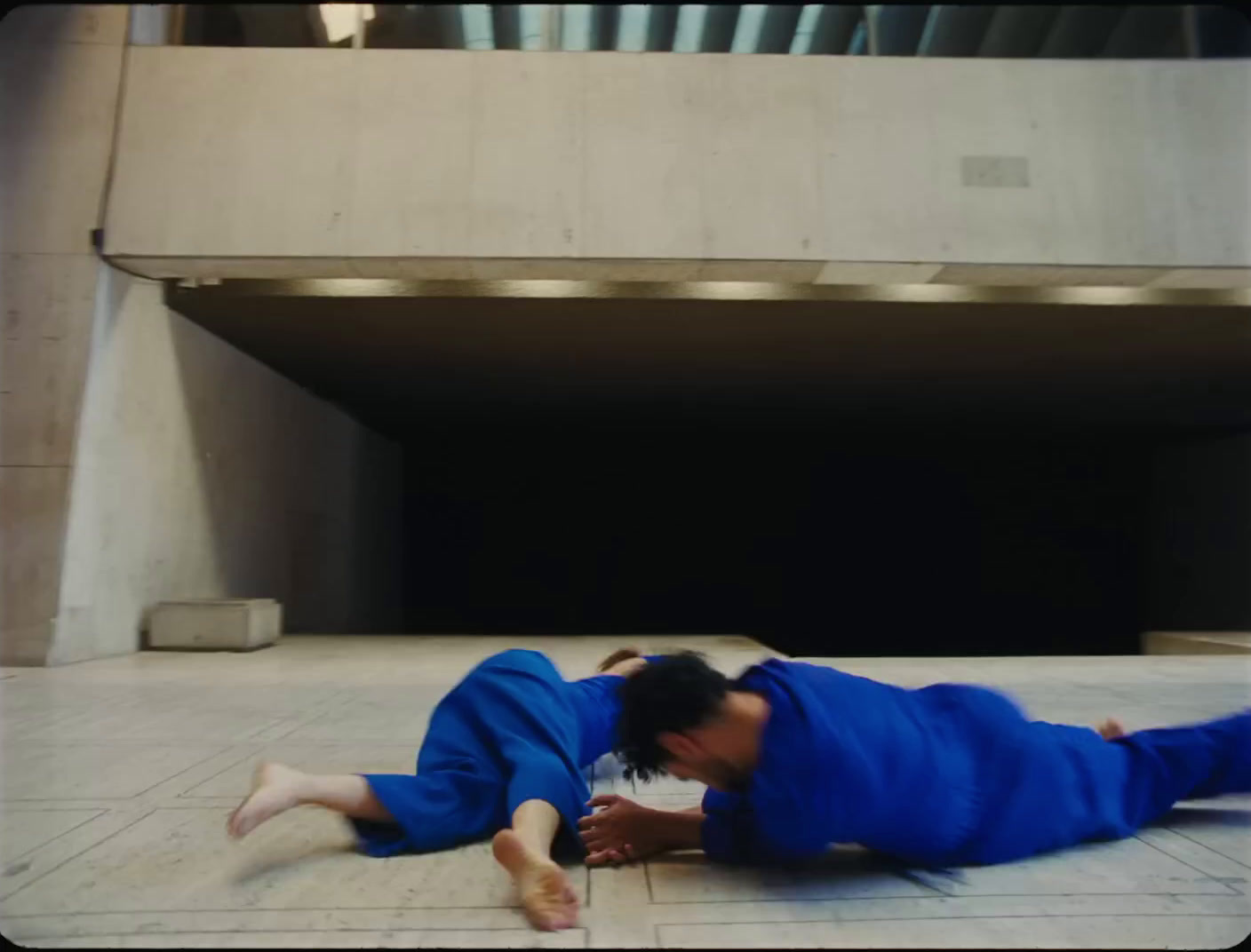 a person laying on the ground in a tunnel