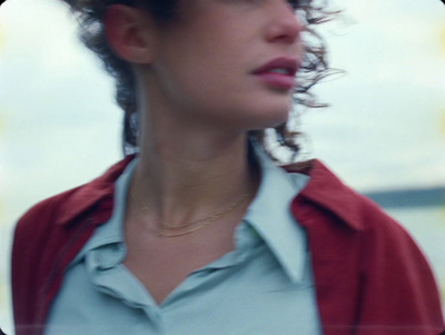 a woman with curly hair wearing a red jacket