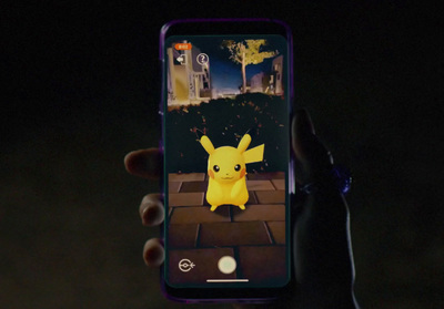 a person taking a picture of a pikachu