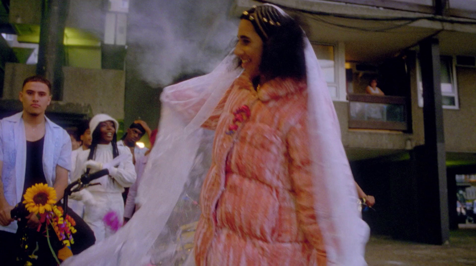 a woman in a wedding dress walking down the street