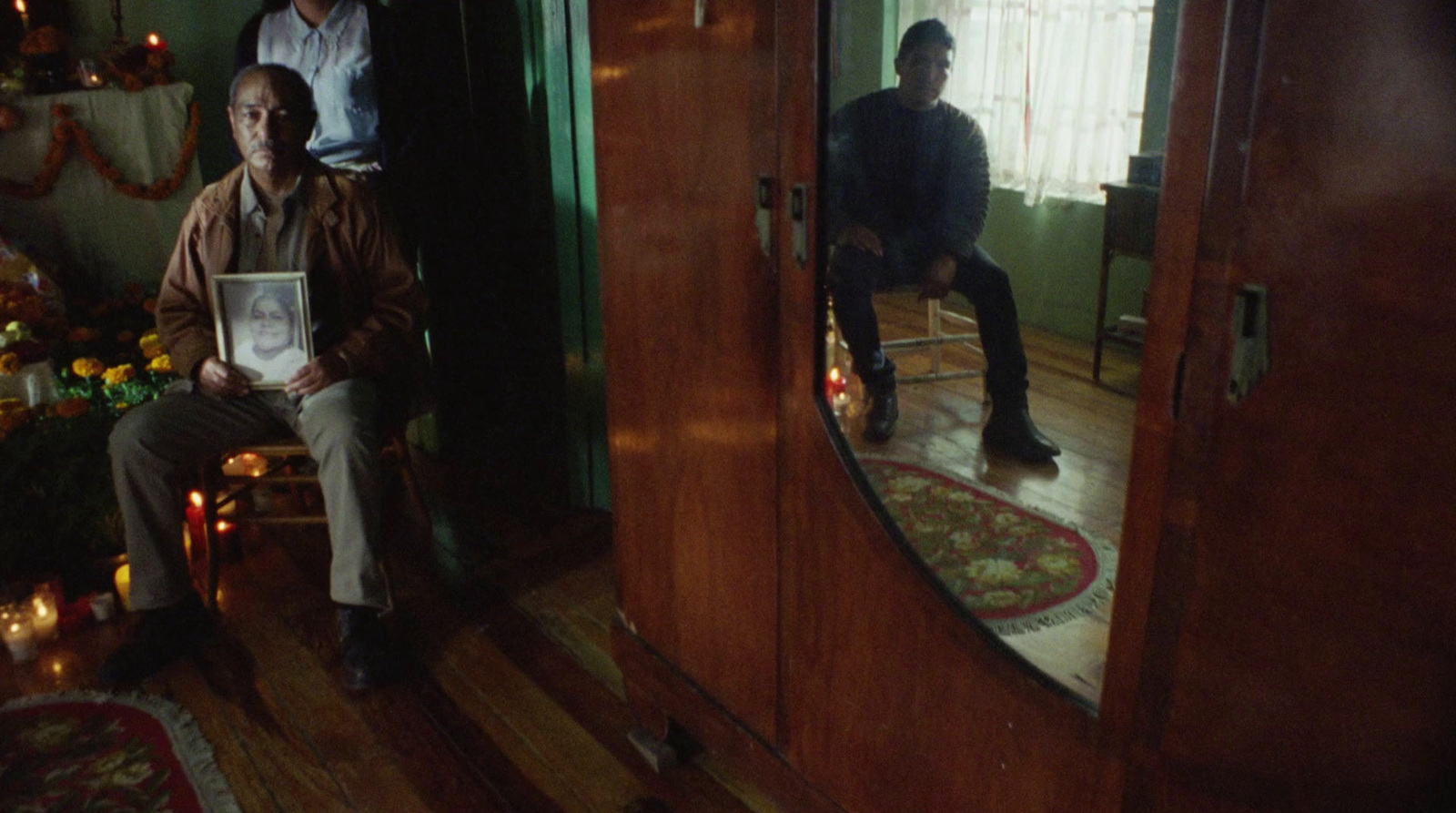 a man sitting on a chair in front of a mirror