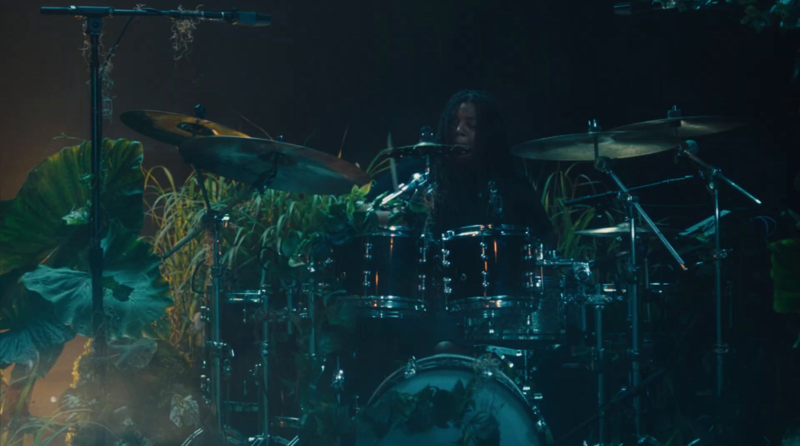 a man playing drums in front of a drum set