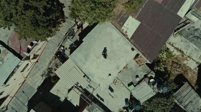 an aerial view of a roof with a person walking on it