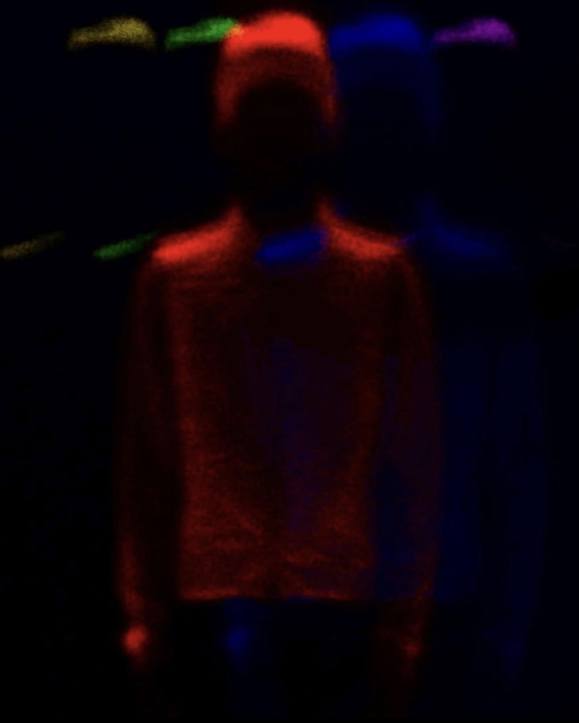 a blurry image of a person standing in the dark