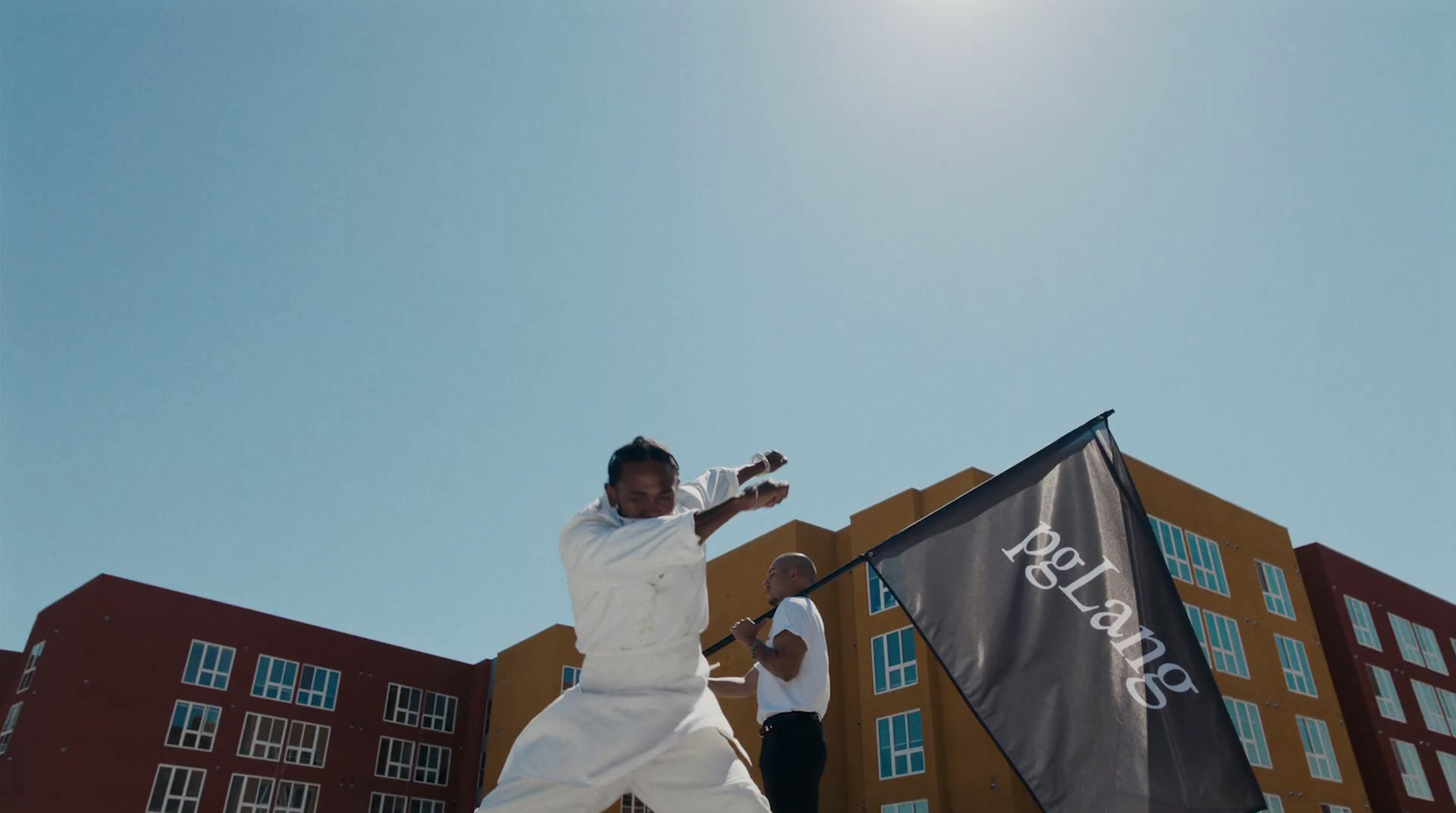 a man in a white outfit swinging a tennis racquet