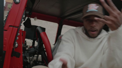 a man in a white shirt and a brown hat