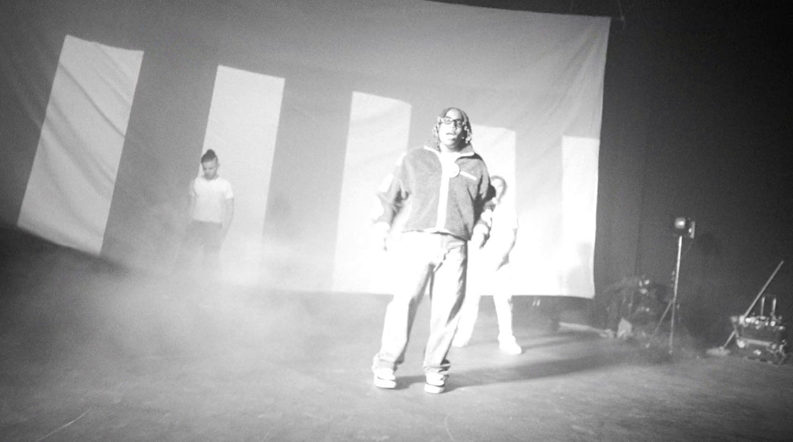 a man standing on a stage in front of a curtain