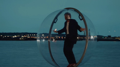 a man in a suit and tie standing inside a bubble