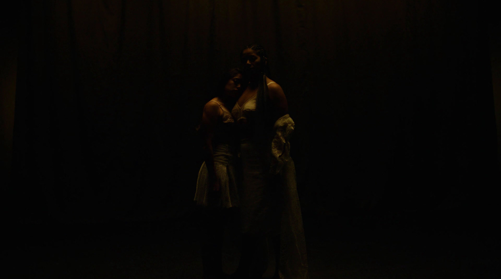 a couple of people standing in a dark room