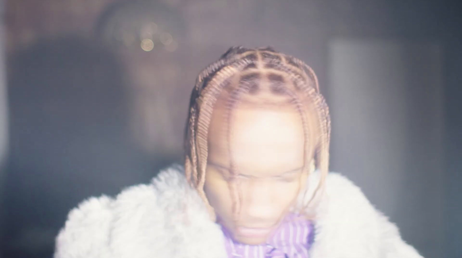 a woman with braids and a purple shirt