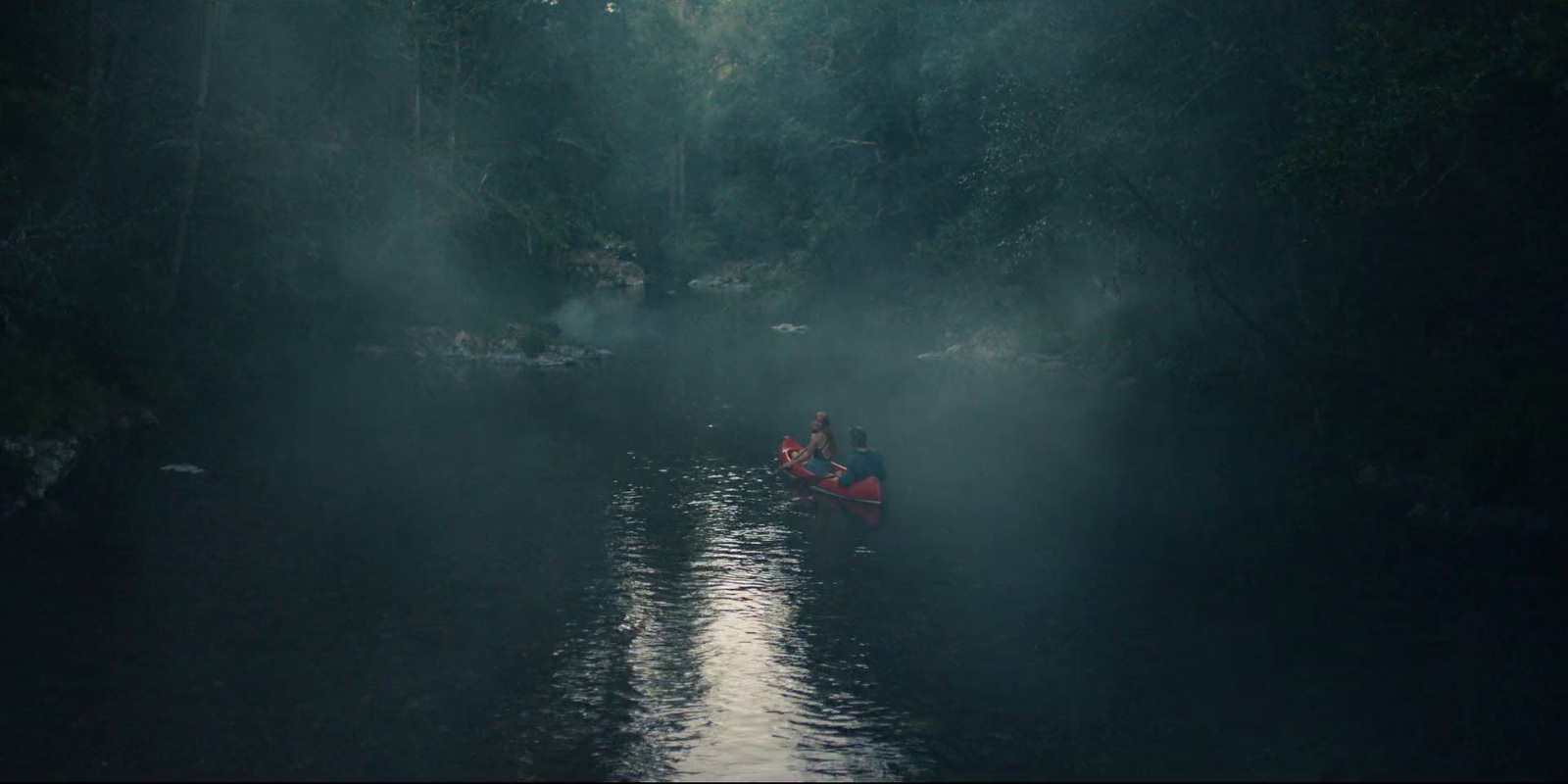 a group of people in a boat on a river