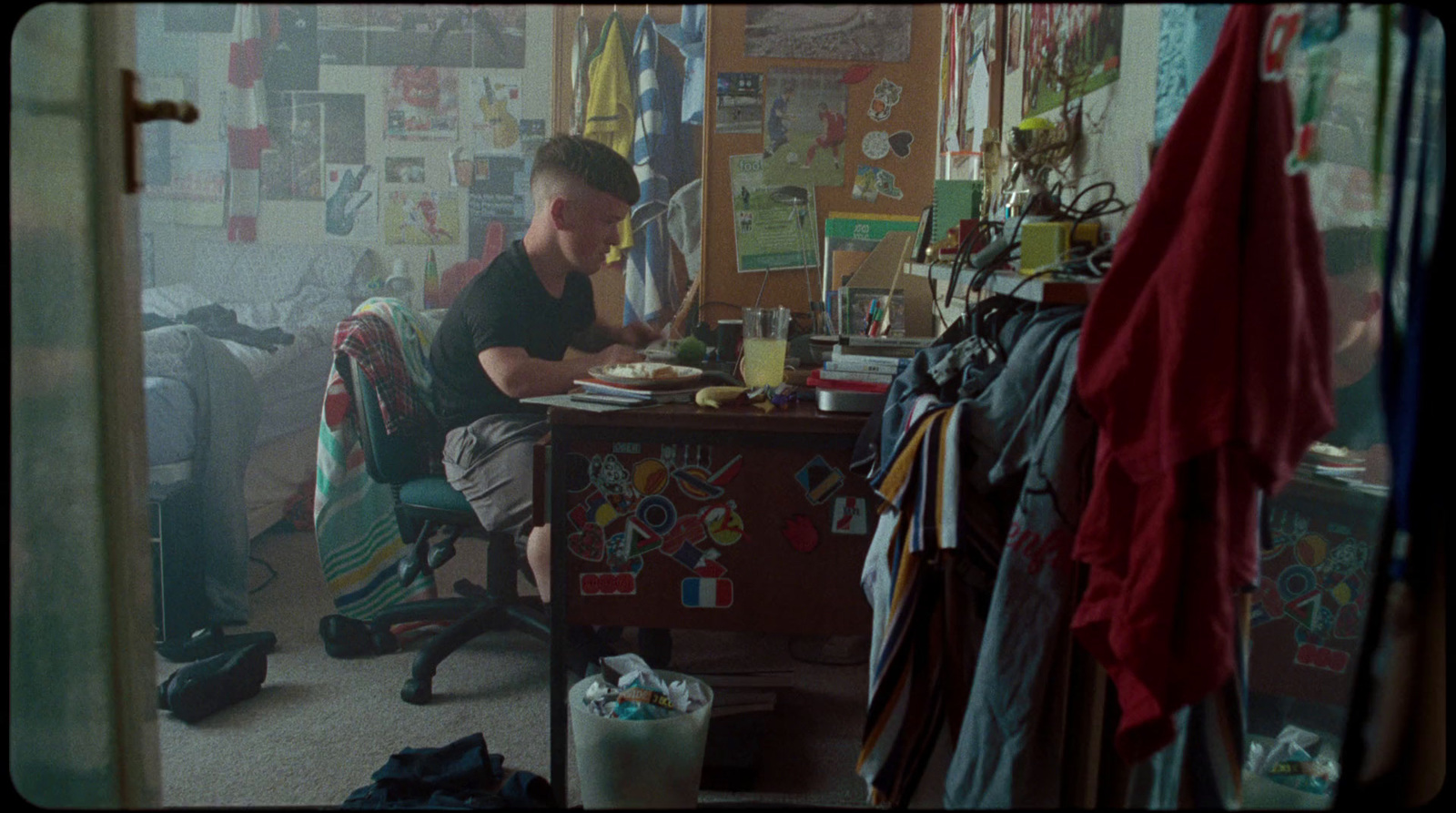 a man sitting at a table in a messy room