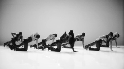 a black and white photo of a group of dancers