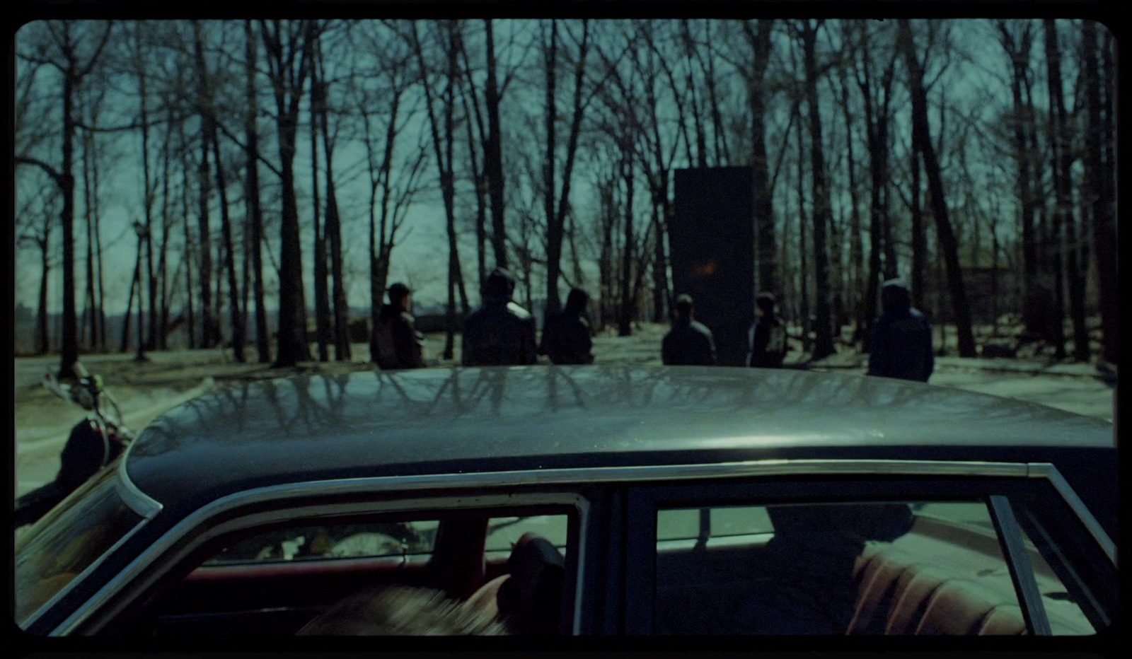 a car parked in front of a group of people