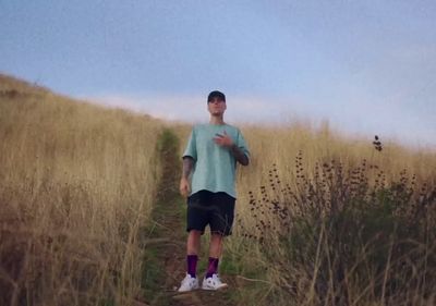 a man standing in a field with a frisbee