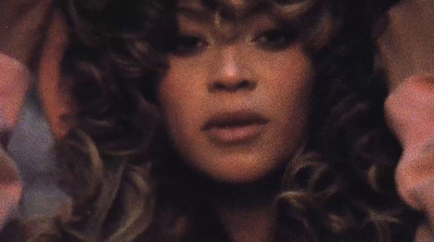 a close up of a person with curly hair