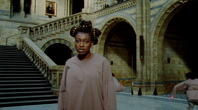 a woman standing in front of some stairs