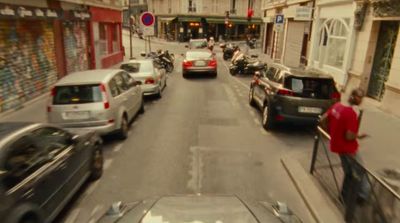 a street filled with lots of traffic next to tall buildings